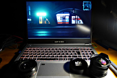 Lumix 20mm f/1.7 AF pancake lens and Risespray 7.5mm f/2.8 fish-eye lens sitting on my Clevo N150CU Debian Linux laptop.