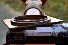 2026-08-12 Lumix DMC-GX7 camera with Hanimex 400mm lens and Tamron 2x Teleconverter mounted on Benbo Trekker tripod, with generic Arca-type quick release. Sun filter is a 90 mm x 110 mm welding glass, glued to a 72 mm - 82 mm step-up ring using black silicone bath sealer.