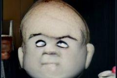craiyon_001045_Ian_Hislop_stuffed_head_first_into_a_large_bowl_of_trifle_br_