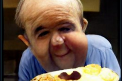 craiyon_001048_Ian_Hislop_stuffed_head_first_into_a_large_bowl_of_trifle_br_