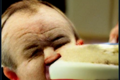 craiyon_001328_Ian_Hislop_pushed_head_first_into_a_large_bowl_of_trifle_br_