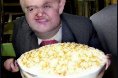 craiyon_001337_Ian_Hislop_pushed_head_first_into_a_large_bowl_of_trifle_br_