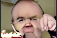 craiyon_002014_Ian_Hislop_pushed_face_first_into_a_large_bowl_of_trifle_br_
