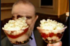 craiyon_002035_Ian_Hislop_pushed_face_first_into_a_large_bowl_of_trifle_br_