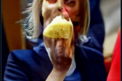 craiyon_114644_Liz_Truss_eating_large_cheese_br_