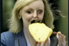 craiyon_114725_Liz_Truss_eating_large_cheese_br_