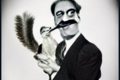 craiyon_154425_Groucho_Marx_eating_a_squirrel_br_