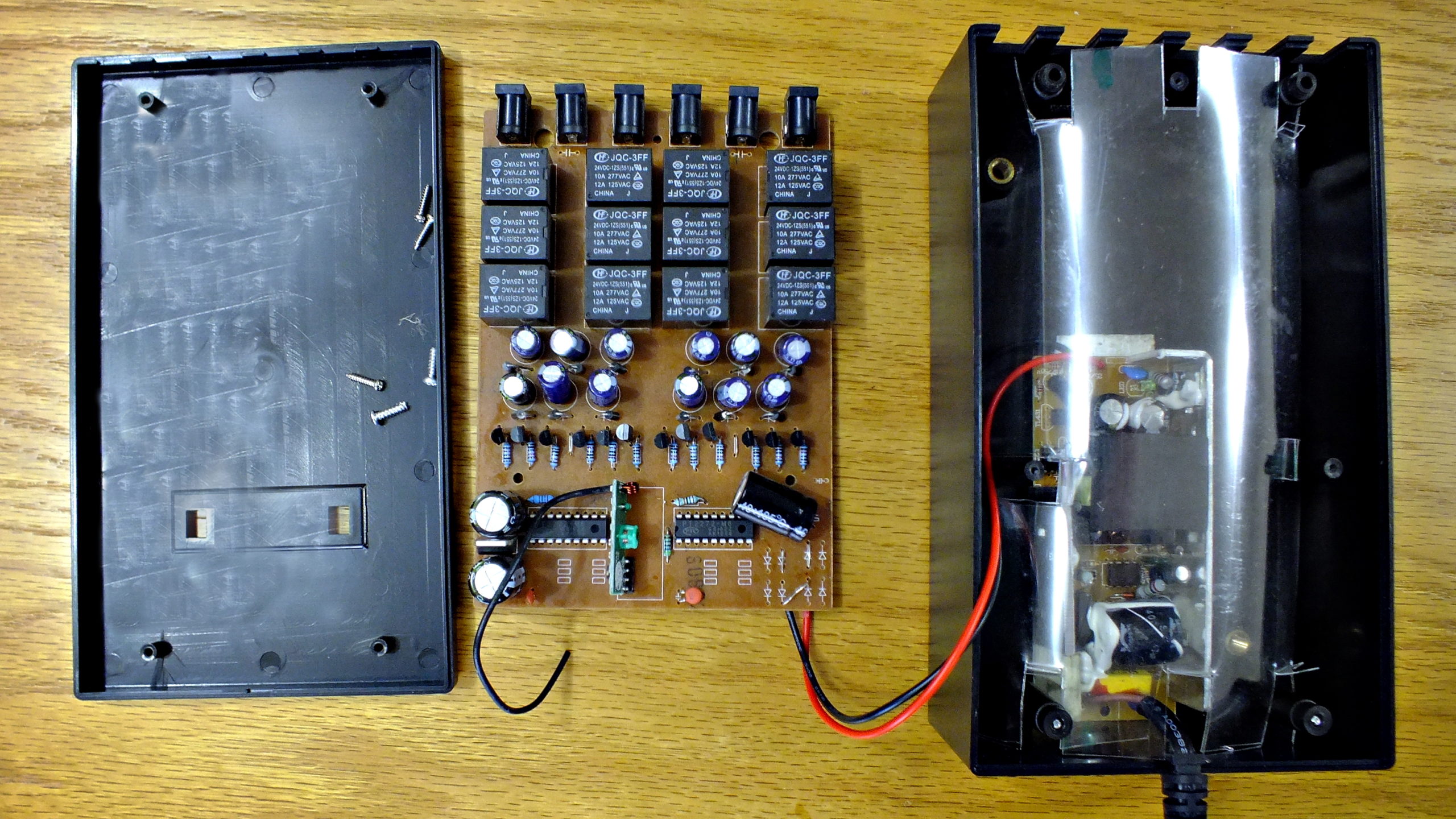 Control unit. Left: lid and cabinet screws. Centre: RF and relay board in the centre; Right: 230 VAC to 24 VDC switch mode power supply already fitted black ABS cabinet.